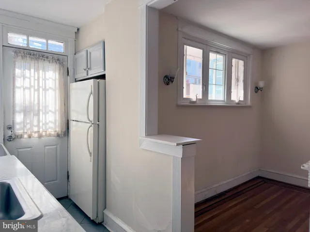 a view of a kitchen with a refrigerator and window