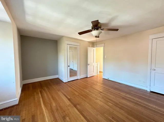 a view of an empty room and wooden floor