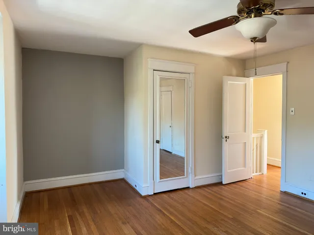 a view of an empty room and wooden floor