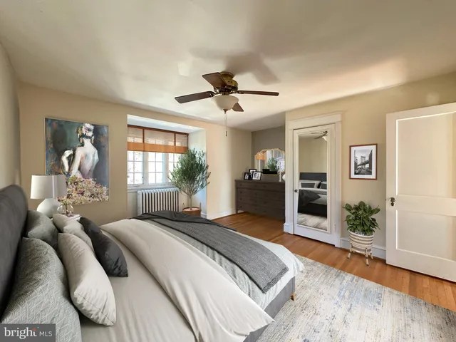 a bedroom with a bed chandelier and a window