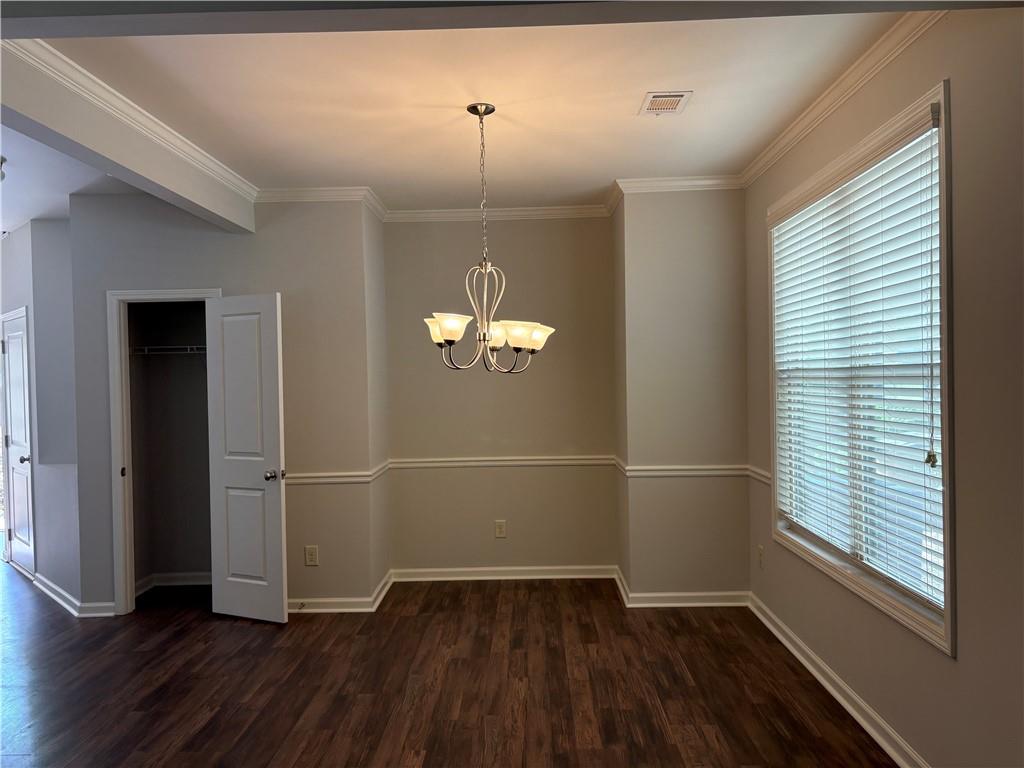 5934 Watersdown Way Flowery Branch, GA 30542 - Photo 6 of 28 an empty room with wooden floor and windows