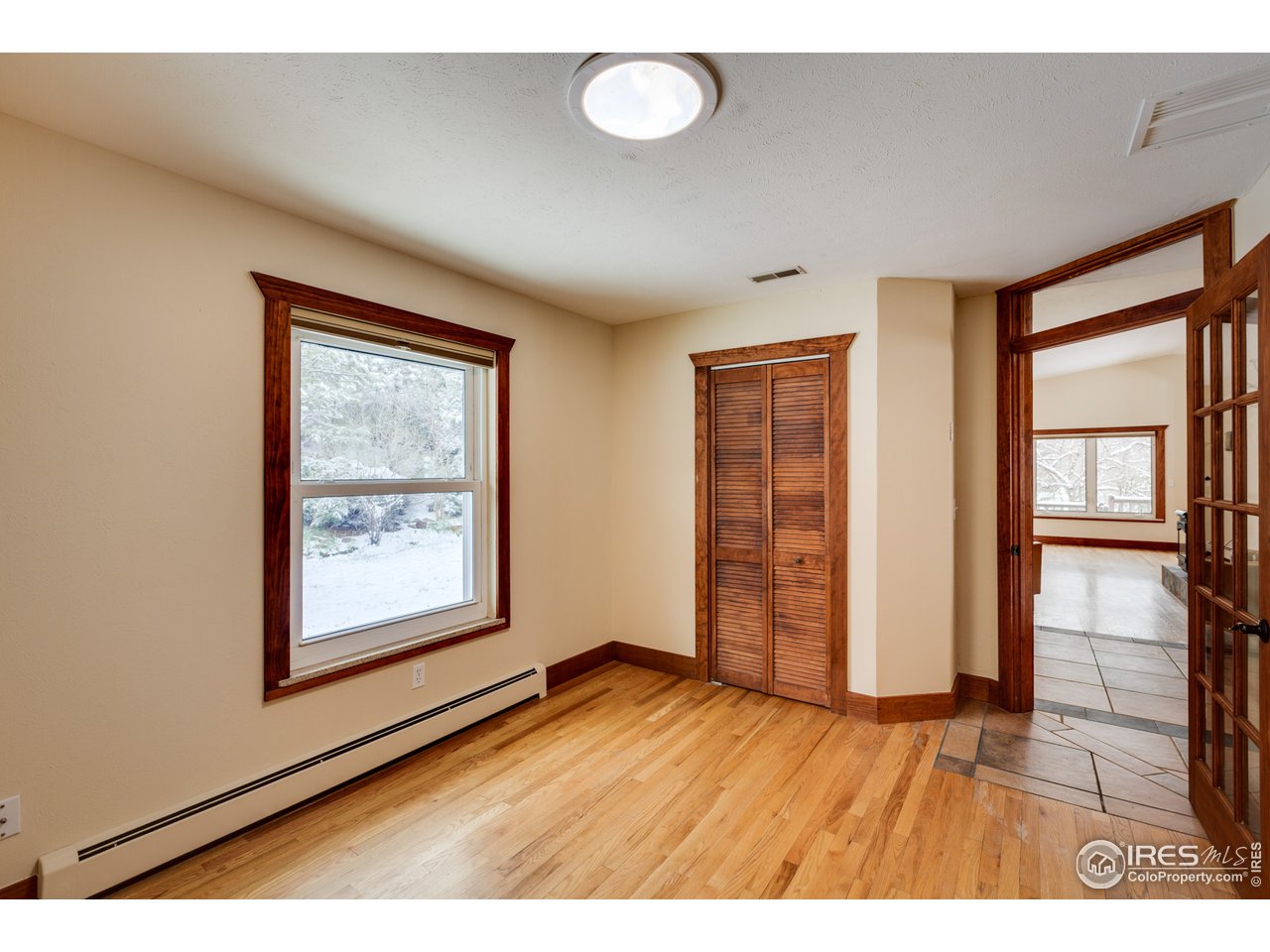7172 Olde Stage Road Boulder, CO 80302 - Photo 11 of 35 an empty room with wooden floor and windows