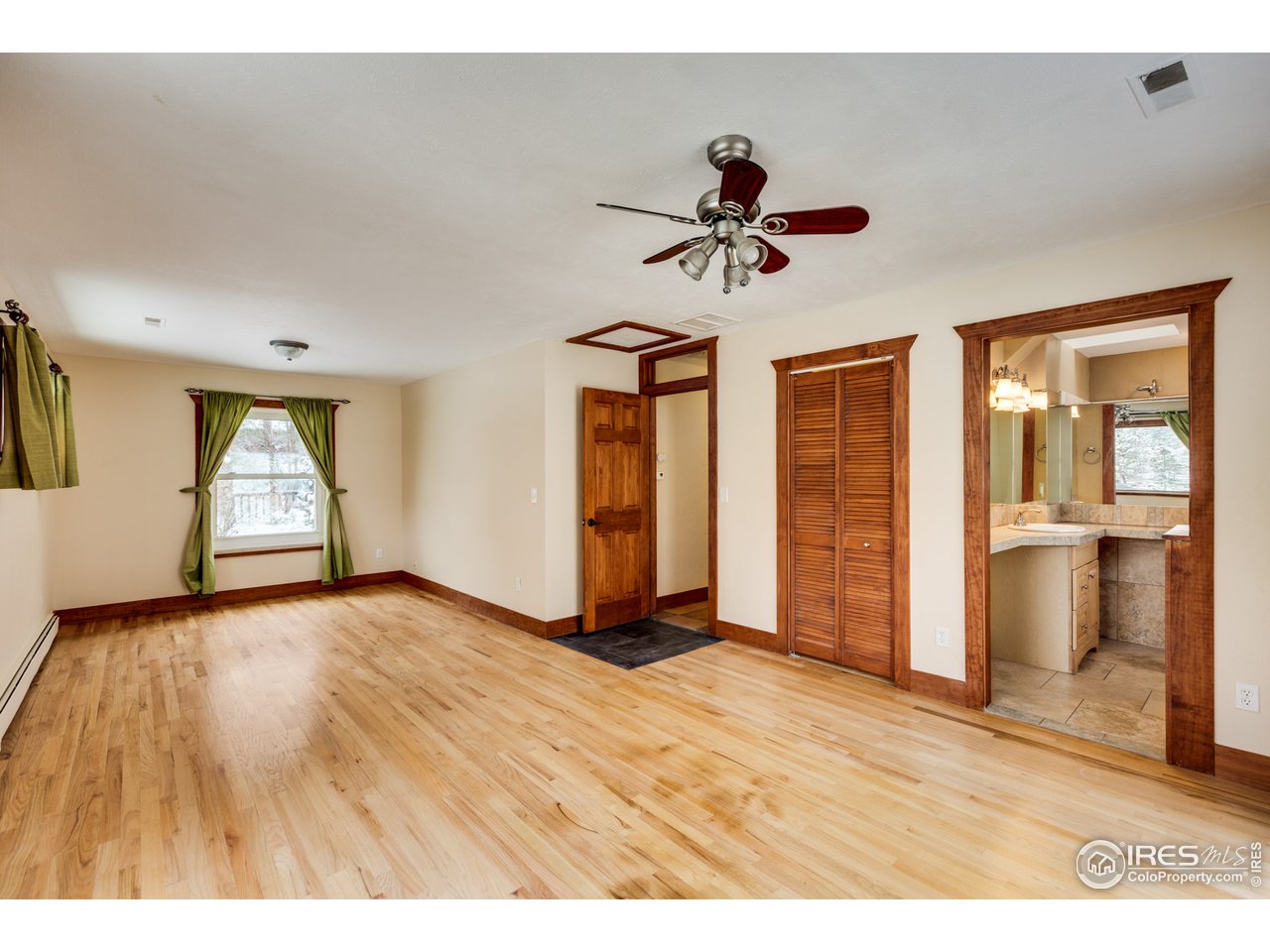 7172 Olde Stage Road Boulder, CO 80302 - Photo 14 of 35 a view of empty room with wooden floor and window
