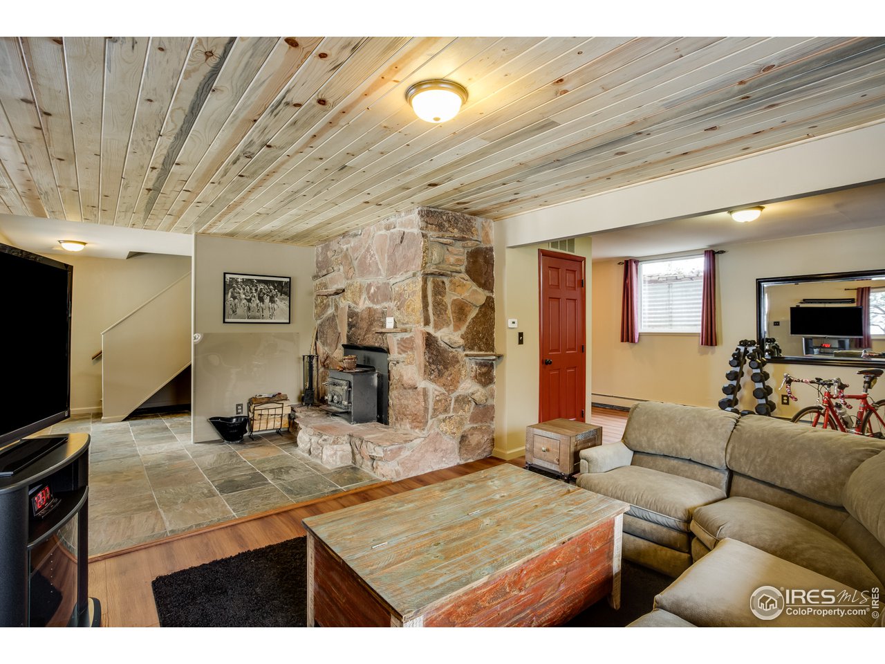 7172 Olde Stage Road Boulder, CO 80302 - Photo 17 of 35 a living room with furniture and a flat screen tv