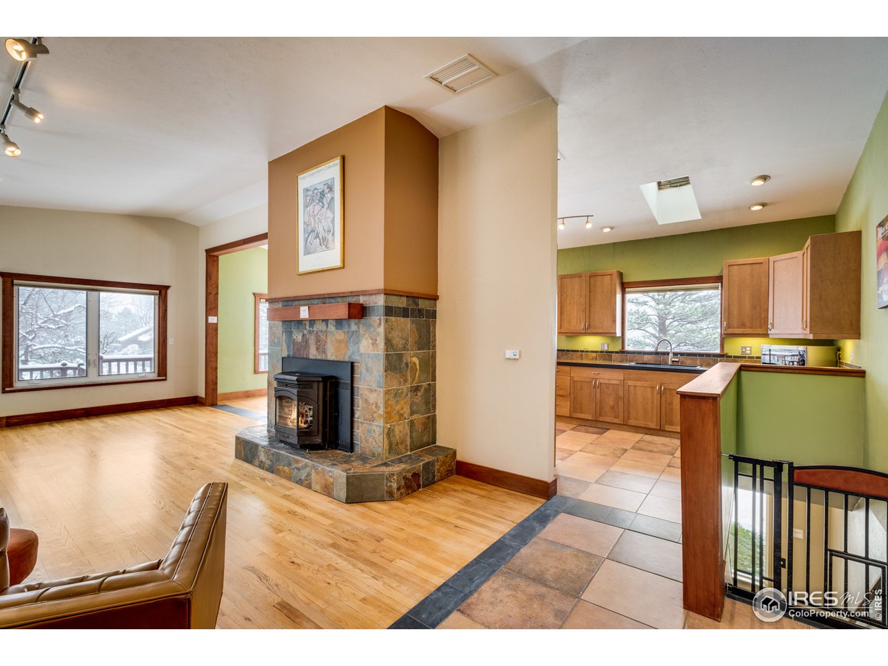7172 Olde Stage Road Boulder, CO 80302 - Photo 4 of 35 a living room with furniture a fireplace and a flat screen tv