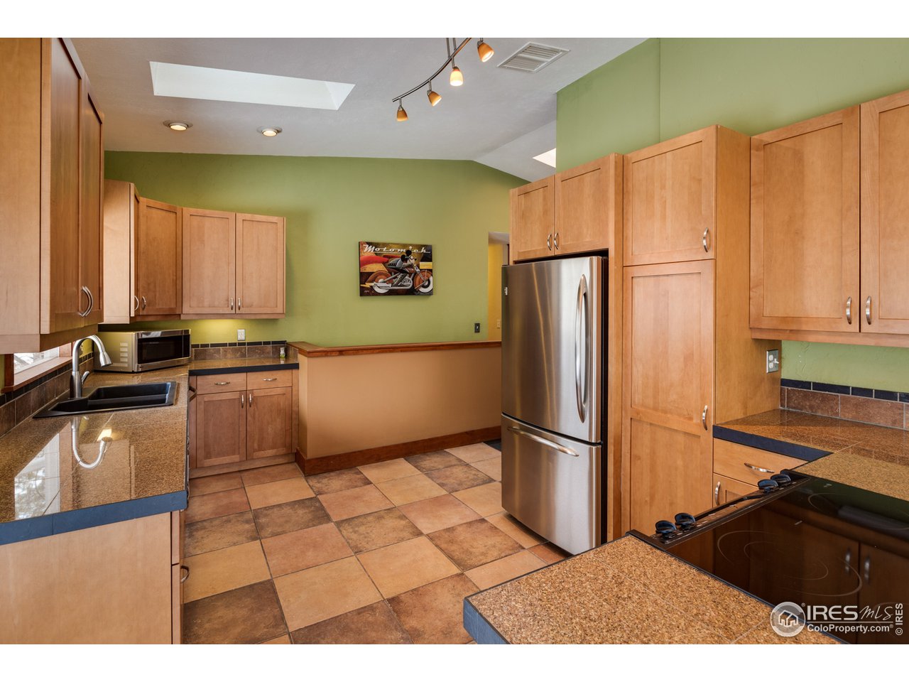 7172 Olde Stage Road Boulder, CO 80302 - Photo 10 of 35 a kitchen with stainless steel appliances granite countertop a refrigerator a sink and a stove