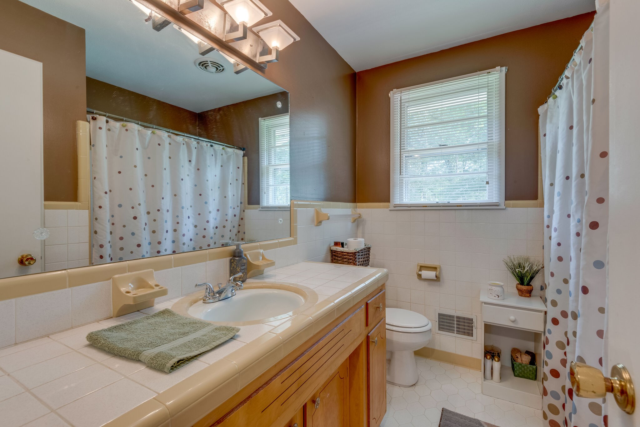 101 Duke Road Dickson, TN 37055 - Photo 22 of 30 a bathroom with a granite countertop sink a toilet a mirror and shower