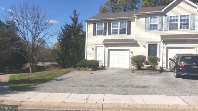 a view of a house with a patio and a yard