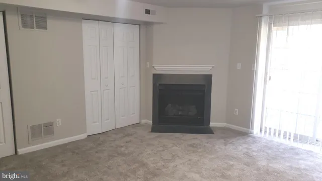 a view of an empty room with a fireplace