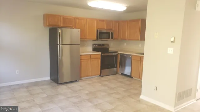 a kitchen with refrigerator cabinets and stainless steel appliances