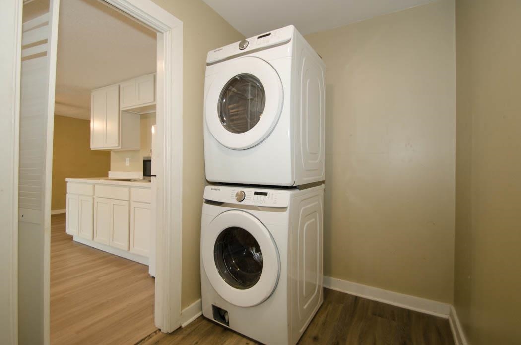 4572 Princeton Road Memphis, TN 38117 - Photo 24 of 24 Laundry area with dark wood-style flooring and stacked washer and dryer