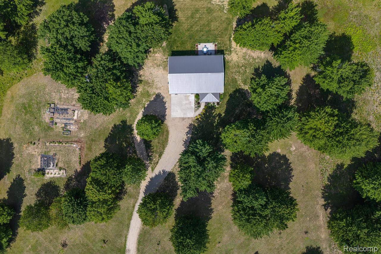 2418 South 41st Road South Cadillac, MI 49601 - Photo 26 of 57 Aerial perspective showcasing a single-story residence with a light-colored metal roof