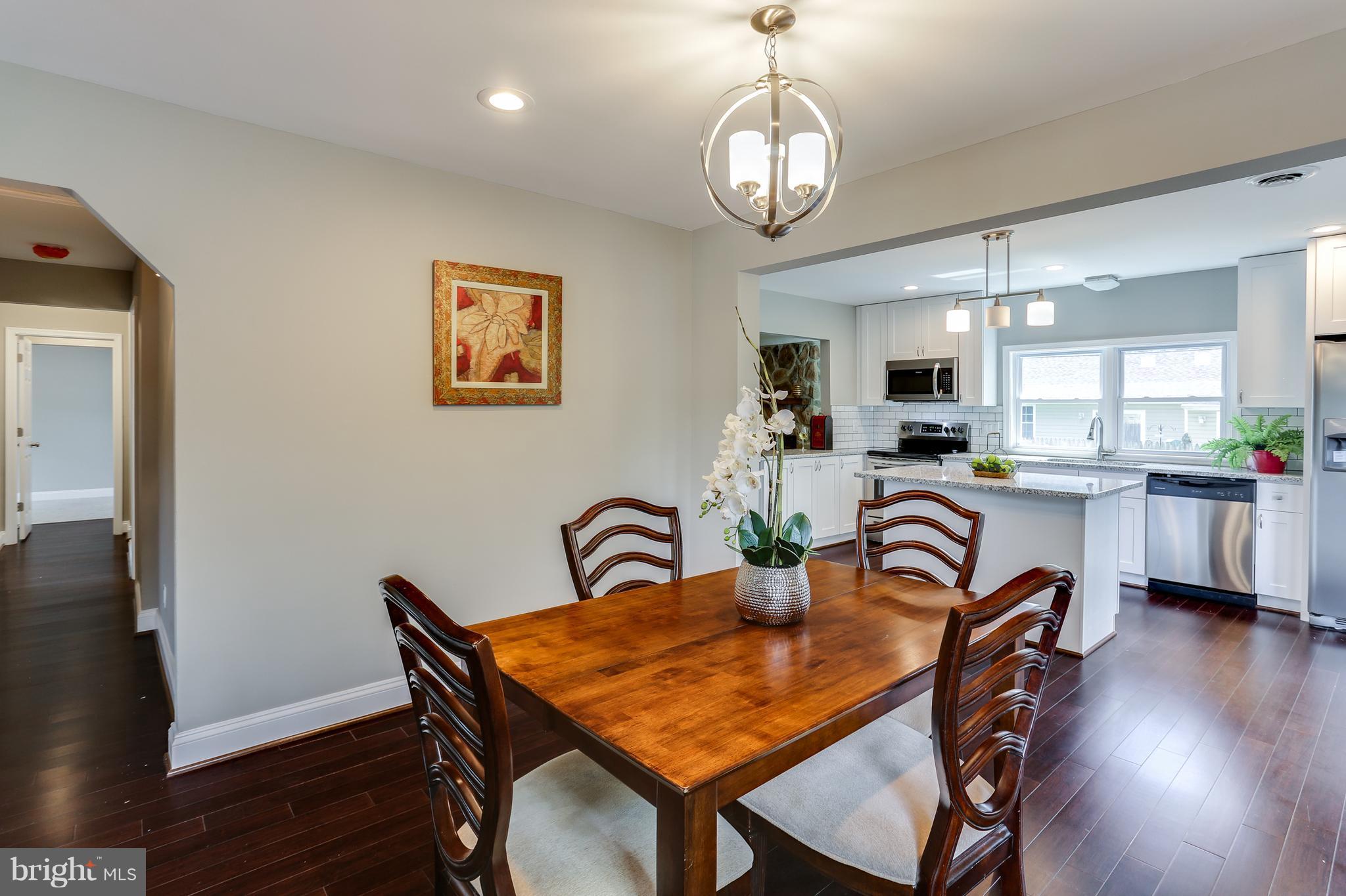 1700 Quantico Road Edgewater, MD 21037 - Photo 18 of 25 a dining room with furniture a chandelier and wooden floor