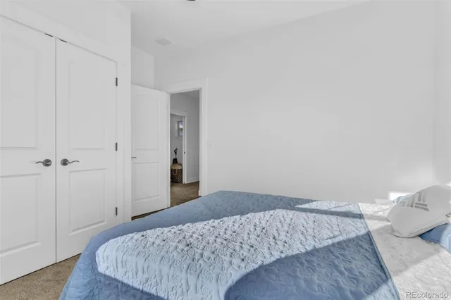 a bedroom with a bed and pillows