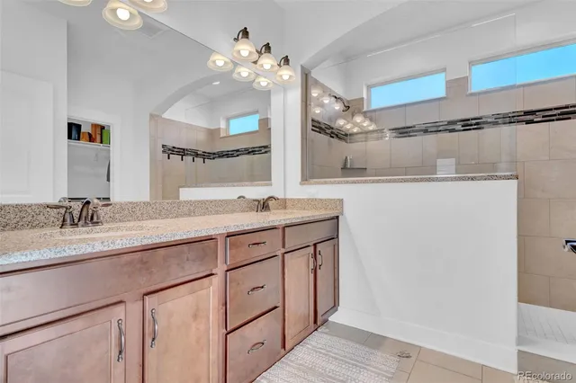 a bathroom with a sink vanity granite and a mirror