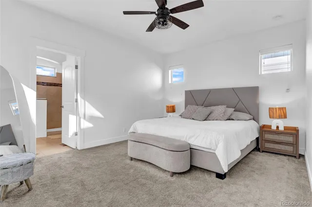 a spacious bedroom with a bed and a window