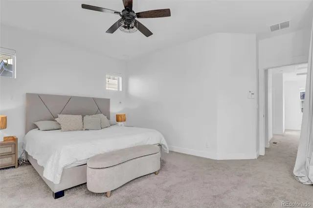 a bedroom with a bed and a night stand