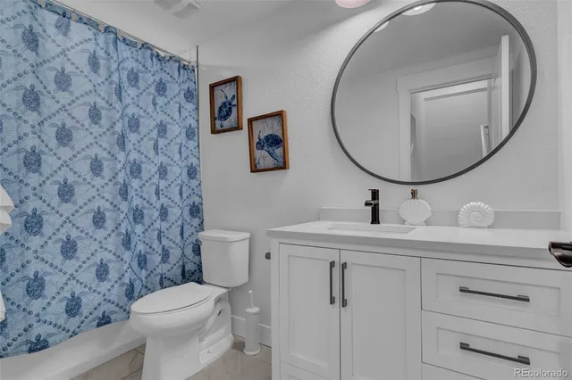 a bathroom with a toilet a sink and a mirror