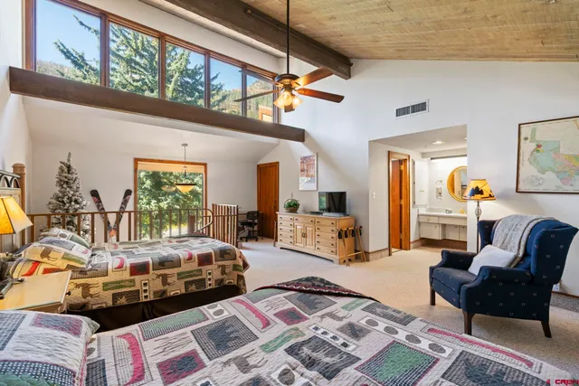 a bedroom with furniture and a large window