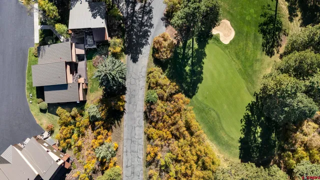 an aerial view of a house with swimming pool and garden