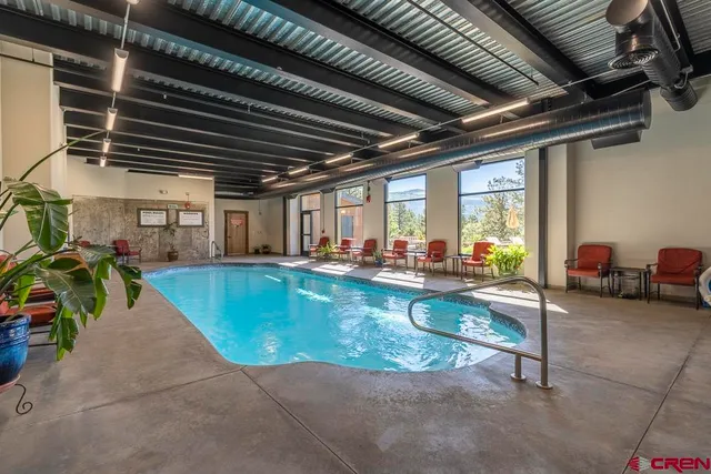 a view of swimming pool with outdoor seating