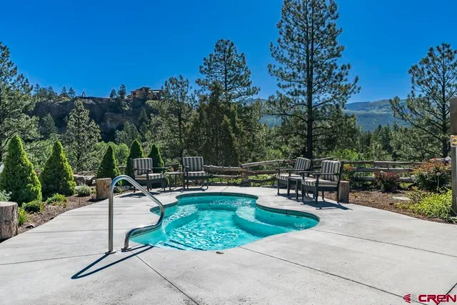 a view of a patio with a table and chairs