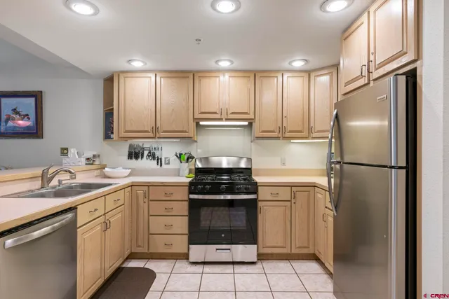 a kitchen with a sink stove and refrigerator