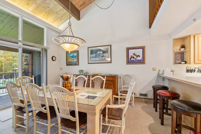 a view of a dining room with furniture and chandelier
