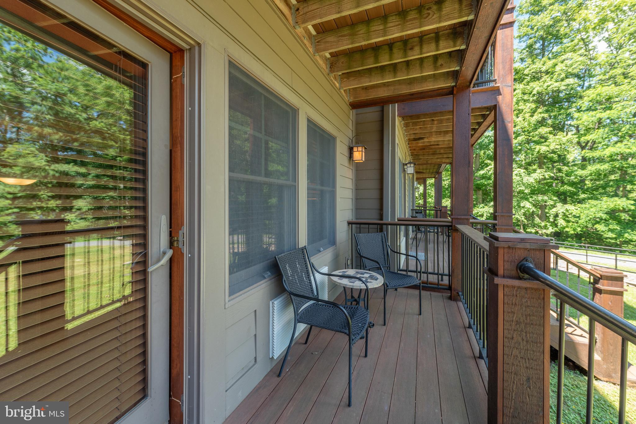 565 Glendale Road, Unit 103B Oakland, MD 21550 - Photo 2 of 53 a view of a balcony with chairs