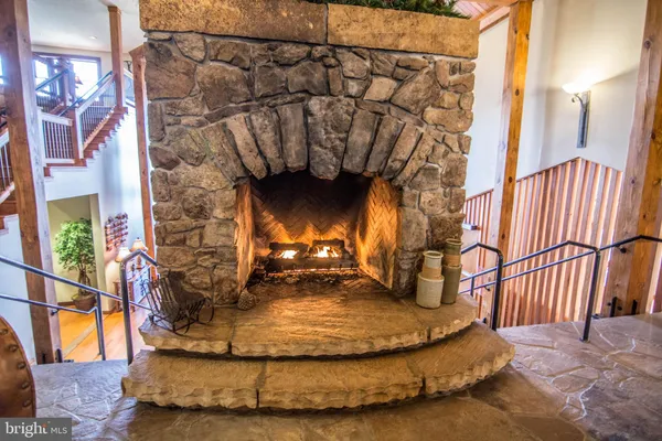 a living room with furniture a fireplace and gym equipment