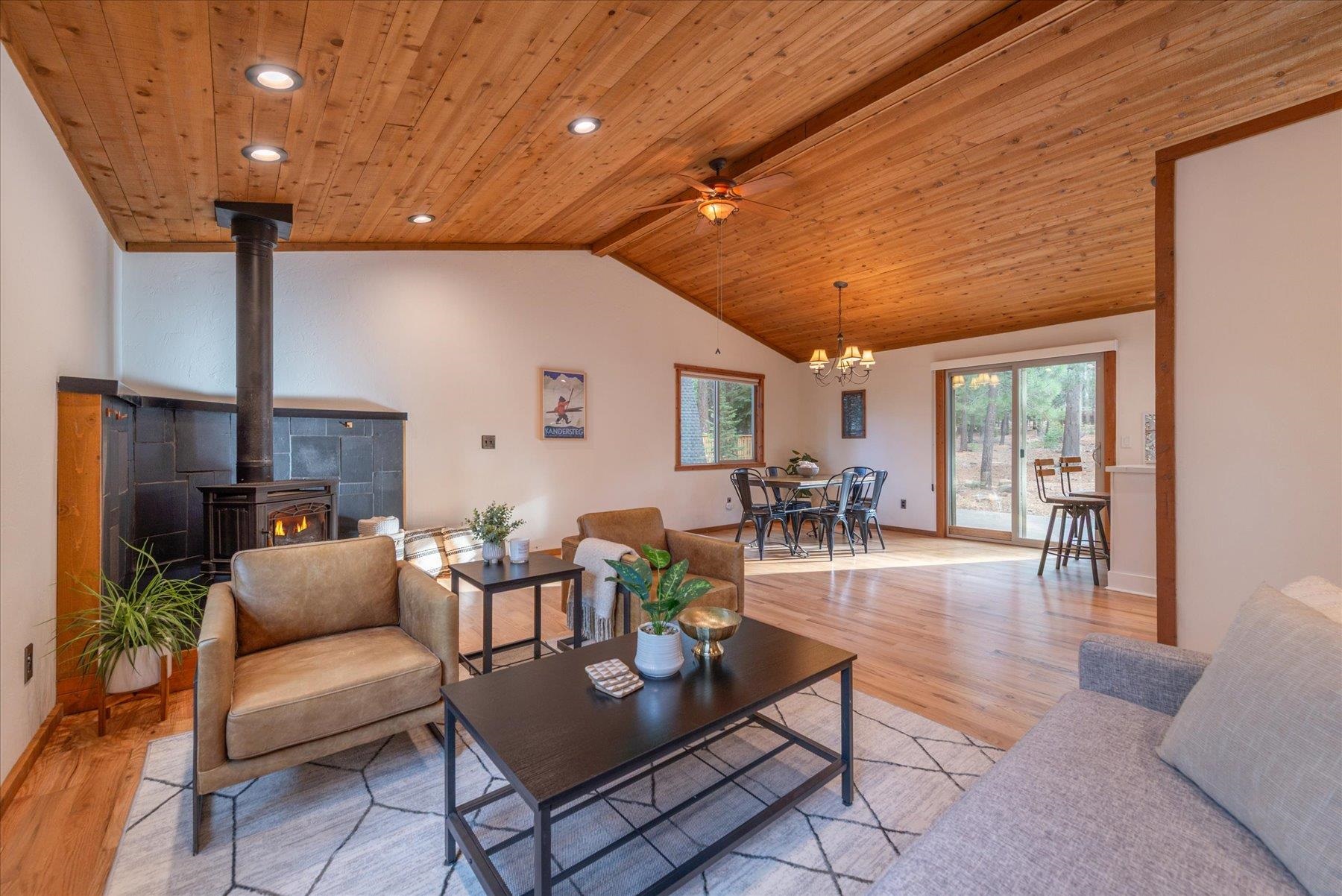 14217 Gyrfalcon Street Truckee, CA 96161 - Photo 18 of 25 a living room with fireplace furniture and a large window