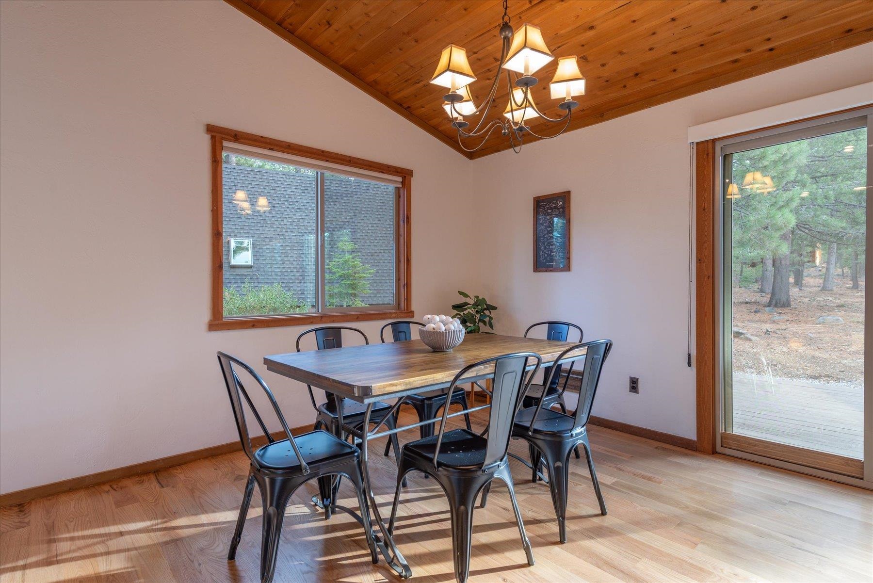 14217 Gyrfalcon Street Truckee, CA 96161 - Photo 22 of 25 a view of a dining room with furniture window and outside view