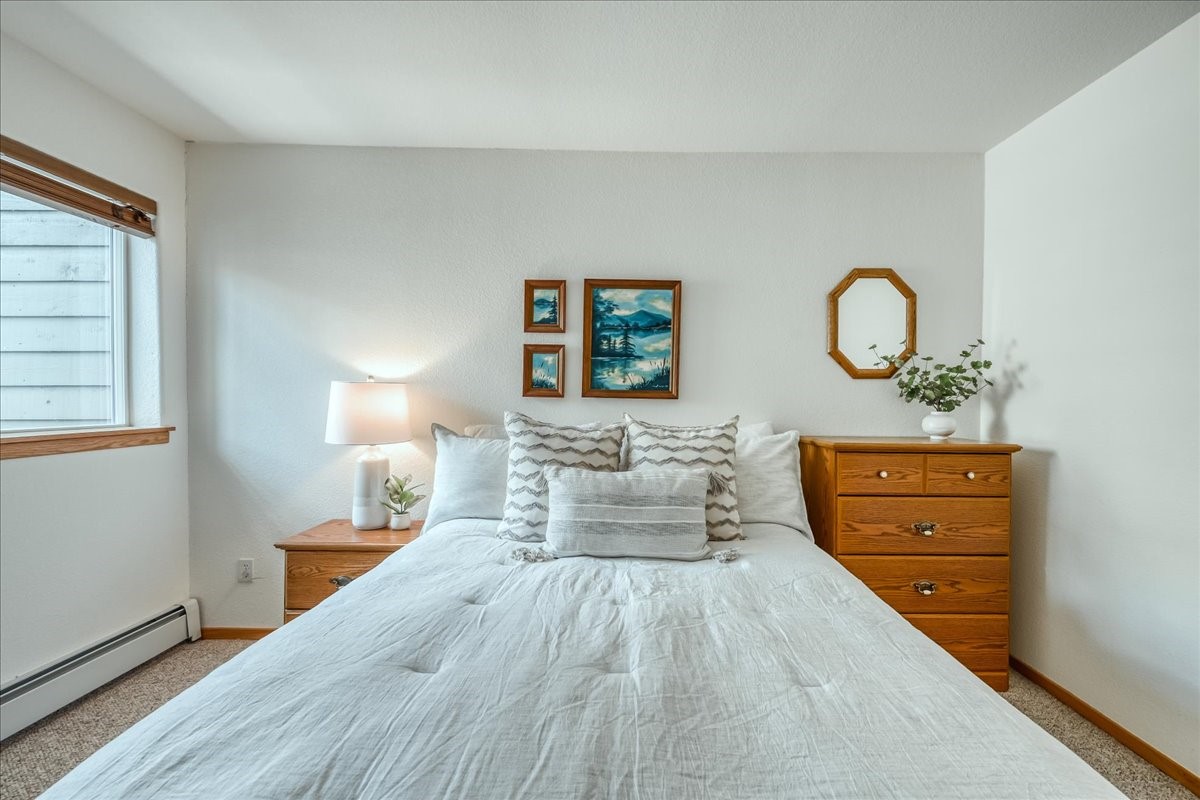 91399 Ryan Gulch Road, Unit B6 Silverthorne, CO 80498 - Photo 15 of 36 a bedroom with furniture and wooden floor