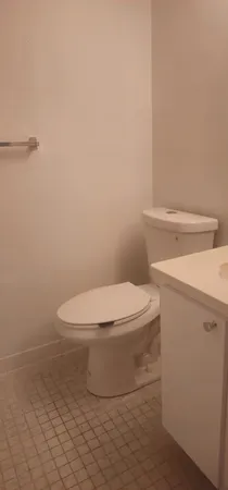 a white toilet sitting next to a white sink