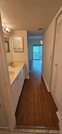 a view of a kitchen with wooden floor and electronic appliances
