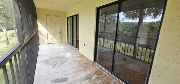 a view of a glass door and the balcony