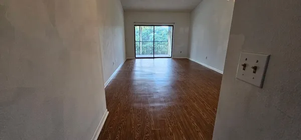 a view of a hallway with wooden floor