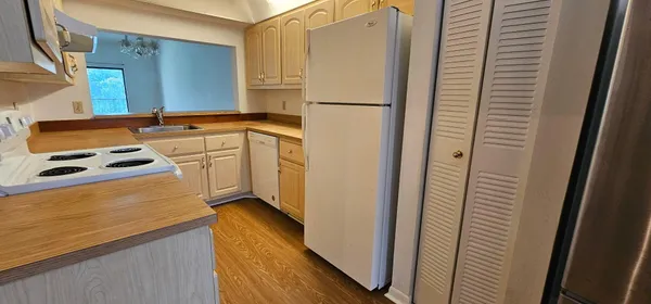 a kitchen with a refrigerator and a stove