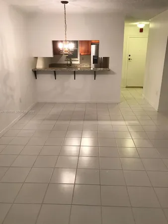 a kitchen with a sink a mirror and shower