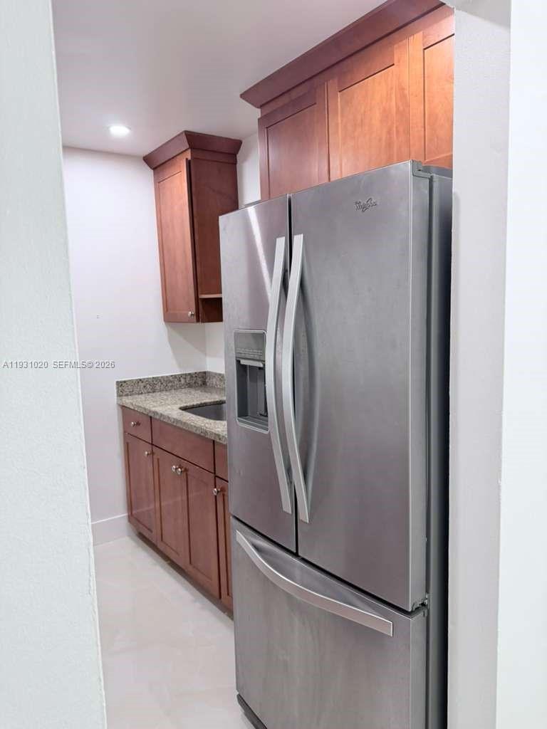 160 Southwest 30th Avenue, Unit 104A Miami, FL 33135 - Photo 13 of 32 a metallic refrigerator freezer sitting inside of a kitchen
