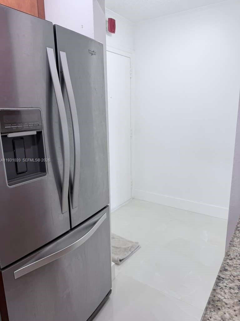160 Southwest 30th Avenue, Unit 104A Miami, FL 33135 - Photo 14 of 32 an empty refrigerator freezer sitting in a kitchen