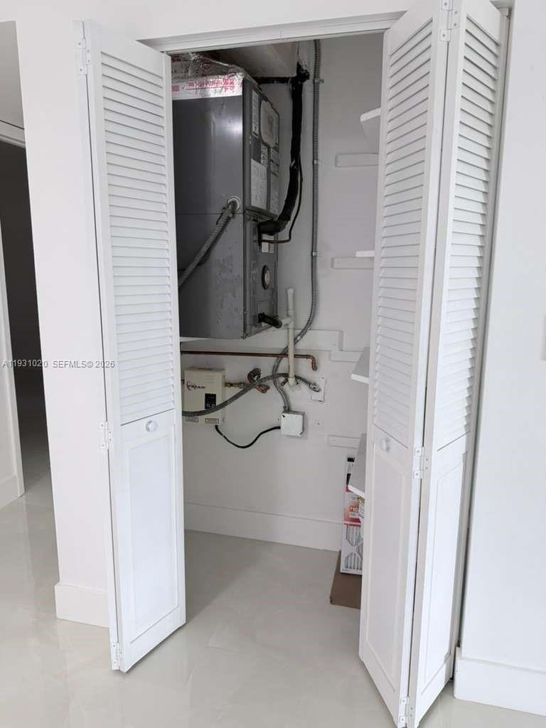 160 Southwest 30th Avenue, Unit 104A Miami, FL 33135 - Photo 15 of 32 a bathroom with a mirror