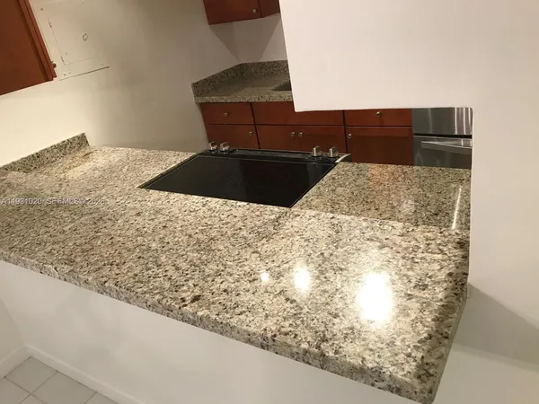 a kitchen with granite countertop cabinets and steel stainless steel appliances