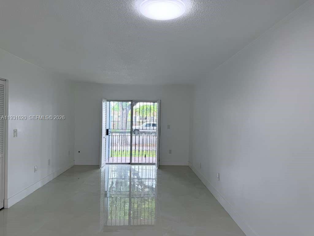 160 Southwest 30th Avenue, Unit 104A Miami, FL 33135 - Photo 16 of 32 an empty room with a window