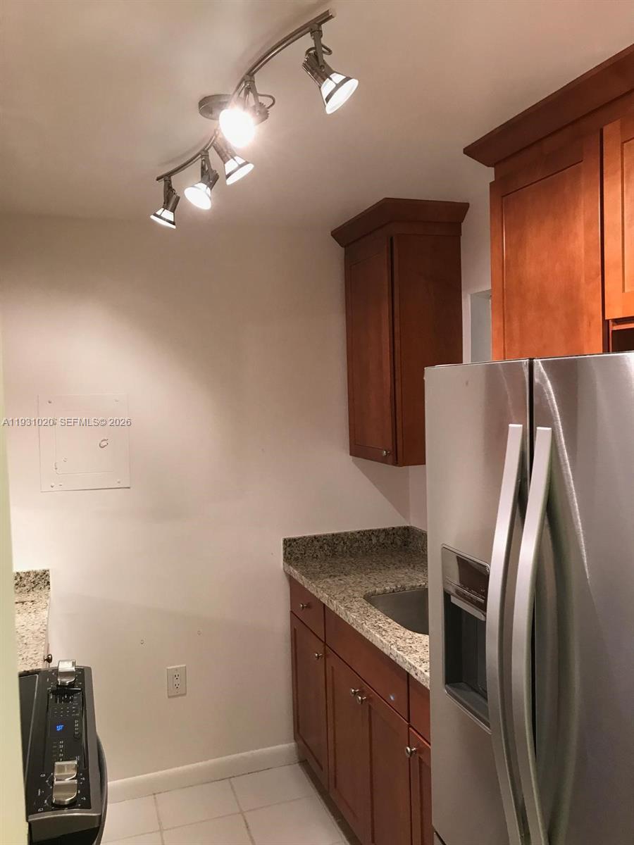 160 Southwest 30th Avenue, Unit 104A Miami, FL 33135 - Photo 17 of 24 a modern kitchen with stainless steel appliances granite countertop a refrigerator and a sink