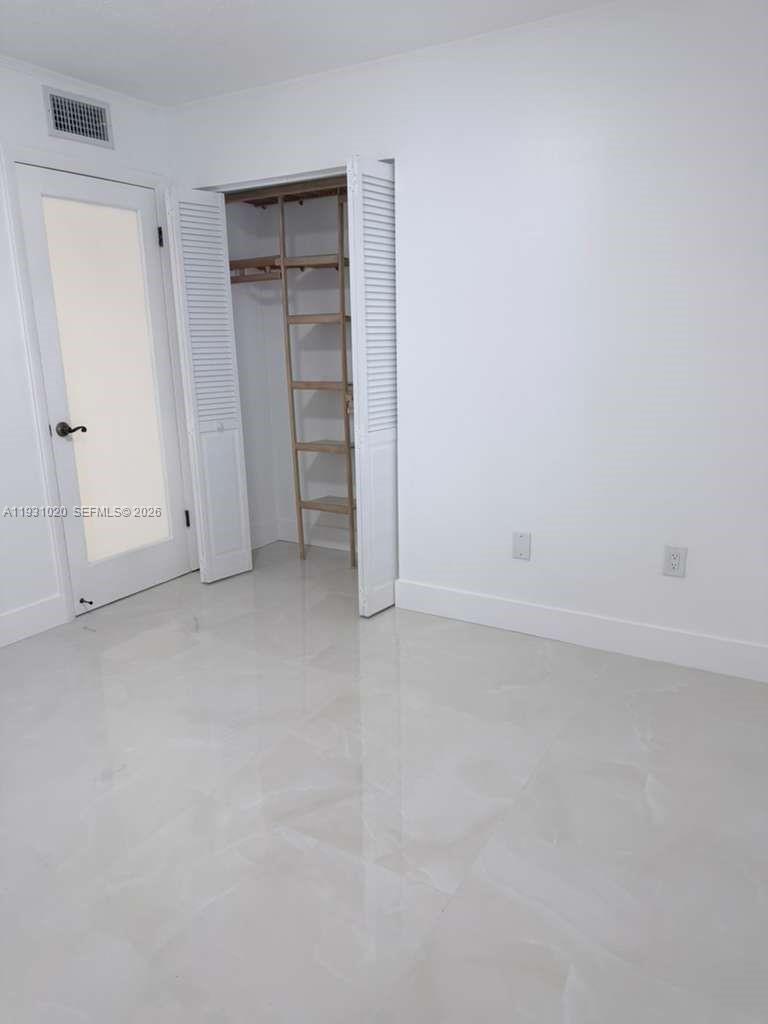 160 Southwest 30th Avenue, Unit 104A Miami, FL 33135 - Photo 19 of 32 an empty room with closet