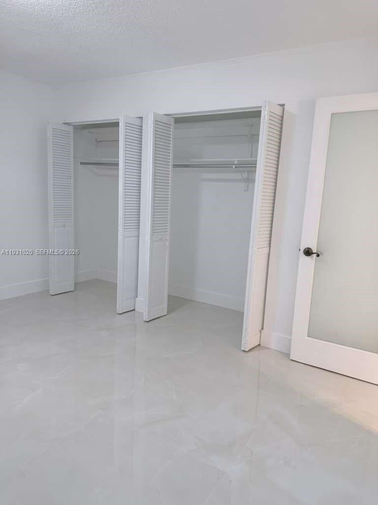 160 Southwest 30th Avenue, Unit 104A Miami, FL 33135 - Photo 23 of 32 an empty room with windows