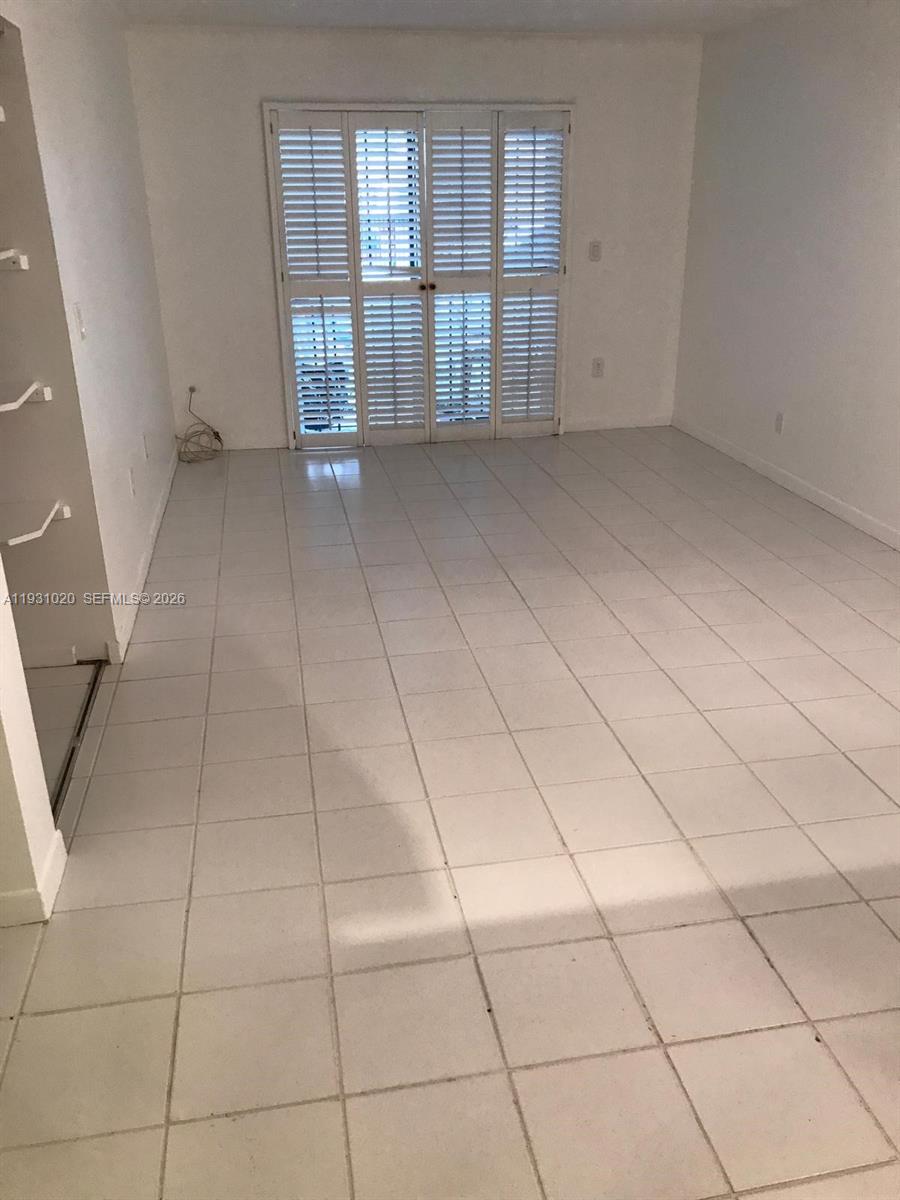 160 Southwest 30th Avenue, Unit 104A Miami, FL 33135 - Photo 24 of 24 a view of an empty room with a window