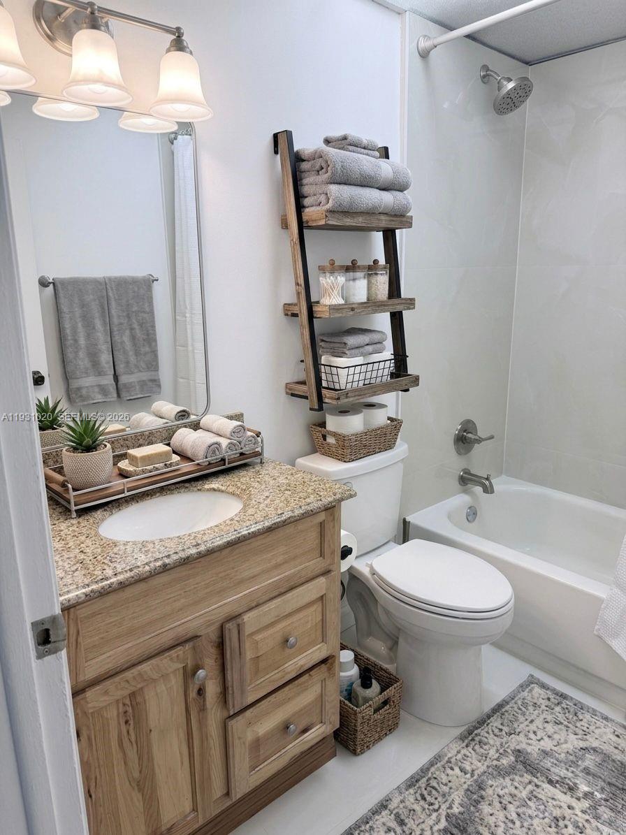 160 Southwest 30th Avenue, Unit 104A Miami, FL 33135 - Photo 3 of 32 a bathroom with a granite countertop toilet sink and mirror