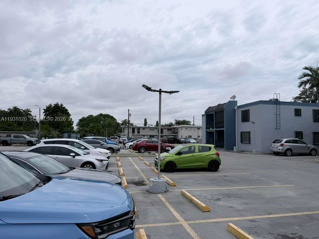 160 Southwest 30th Avenue, Unit 104A Miami, FL 33135 - Photo 32 of 32 a group of cars parked in front of a building